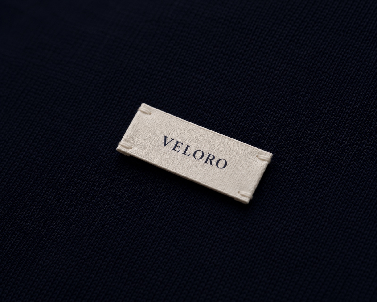 A woven Veloro label on navy knit